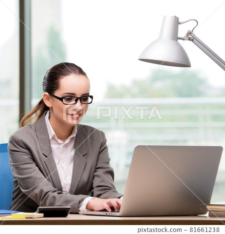 Businesswoman working at her desk Businesswoman working at her desk 81661238