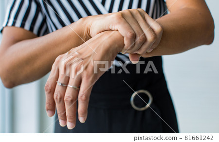 Woman shows hand and hold wrist with feeling pain, suffer, hurt and tingling. Concept of Guillain barre syndrome and numb hands disease effect Woman shows hand and hold wrist with feeling pain, suffer, hurt and tingling. Concept of Guillain barre syndrome and numb hands disease effect 81661242