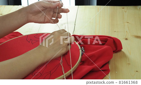 Embroider sewing by woman hand. Craft work and female hands. Handicraft work by thread needle sew knit. Wood frame embroidery hoop. Needlework handicraft crafting quarantine leisure concept. Embroider sewing by woman hand. Craft work and female hands. Handicraft work by thread needle sew knit. Wood frame embroidery hoop. Needlework handicraft crafting quarantine leisure concept. 81661368