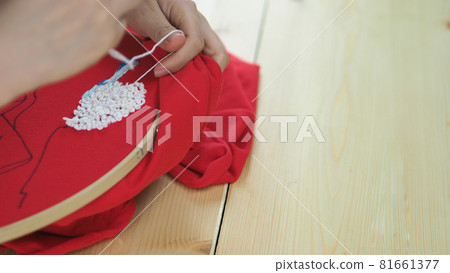 Embroider sewing by woman hand. Craft work and female hands. Handicraft work by thread needle sew knit. Wood frame embroidery hoop. Needlework handicraft crafting quarantine leisure concept. Embroider sewing by woman hand. Craft work and female hands. Handicraft work by thread needle sew knit. Wood frame embroidery hoop. Needlework handicraft crafting quarantine leisure concept. 81661377