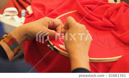 Embroider sewing by woman hand. Craft work and female hands. Handicraft work by thread needle sew knit. Wood frame embroidery hoop. Needlework handicraft crafting quarantine leisure concept. Embroider sewing by woman hand. Craft work and female hands. Handicraft work by thread needle sew knit. Wood frame embroidery hoop. Needlework handicraft crafting quarantine leisure concept. 81661381