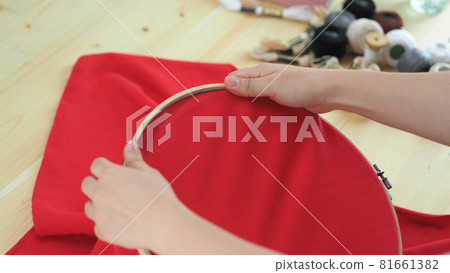 Embroider sewing by woman hand. Craft work and female hands. Handicraft work by thread needle sew knit. Wood frame embroidery hoop. Needlework handicraft crafting quarantine leisure concept. Embroider sewing by woman hand. Craft work and female hands. Handicraft work by thread needle sew knit. Wood frame embroidery hoop. Needlework handicraft crafting quarantine leisure concept. 81661382