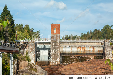 KOUVOLA, FINLAND - SEPTEMBER 20, 2018: Hydroelectric power generation plant and Ankkapurha Industrial Museum at Kymijoki river, Finland KOUVOLA, FINLAND - SEPTEMBER 20, 2018: Hydroelectric power generation plant and Ankkapurha Industrial Museum at Kymijoki river, Finland 81662196