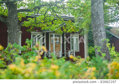 KOUVOLA, FINLAND - SEPTEMBER 20, 2018: Beautiful red old wooden house and big tree on the territory of Anjala manor. KOUVOLA, FINLAND - SEPTEMBER 20, 2018: Beautiful red old wooden house and big tree on the territory of Anjala manor. 81662197