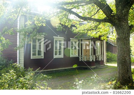 KOUVOLA, FINLAND - SEPTEMBER 20, 2018: Beautiful red old wooden house and big tree on the territory of Anjala manor. KOUVOLA, FINLAND - SEPTEMBER 20, 2018: Beautiful red old wooden house and big tree on the territory of Anjala manor. 81662200