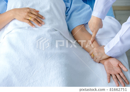 Doctor hold hand of patient on bed in hospital and checkup nervous system for cure and treatment. Concept of Guillain barre syndrome and numb hands disease or vaccine side effect Doctor hold hand of patient on bed in hospital and checkup nervous system for cure and treatment. Concept of Guillain barre syndrome and numb hands disease or vaccine side effect 81662751
