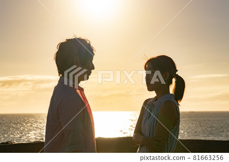A couple talking about love at the beach at dusk A couple talking about love at the beach at dusk 81663256