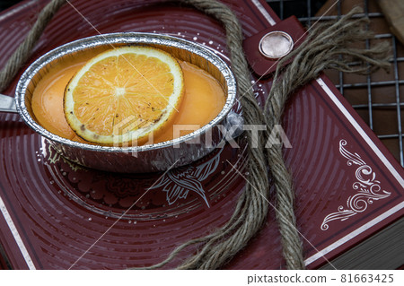 Orange cheese cake on beautiful background. One piece. Orange cheese cake on beautiful background. One piece. 81663425