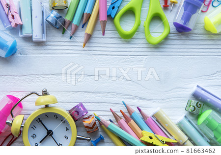 Frame of different stationery on white wooden background 81663462