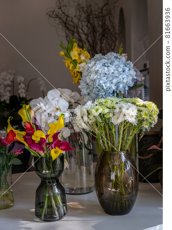 Beautiful bouquet of flowers in Assorted many different glass vases in flower shop. Beautiful bouquet of flowers in Assorted many different glass vases in flower shop. 81663936