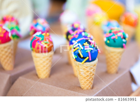 close up of yummy and colorful mini ice cream on waffle cone as a snack wit h pastel concept and signature 81663991