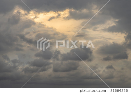 The sun shines through the clouds in the sky. The shape of the clouds evokes imagination and creativity. The sun shines through the clouds in the sky. The shape of the clouds evokes imagination and creativity. 81664236