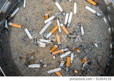 Cigarettes are then left in the ashtray in smoking zone area. Cigarettes are then left in the ashtray in smoking zone area. 81664238