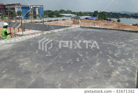 SELANGOR, MALAYSIA -SEPTEMBER, 2014: Construction worker apply layer of bituminous waterproofing at the building roof slab surface. SELANGOR, MALAYSIA -SEPTEMBER, 2014: Construction worker apply layer of bituminous waterproofing at the building roof slab surface. 81671382