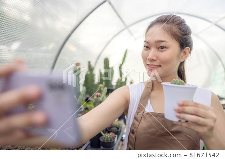Asia woman enjoys gardening with cactus and is the proprietor of a start-up company that sells trees online. Asia woman enjoys gardening with cactus and is the proprietor of a start-up company that sells trees online. 81671542