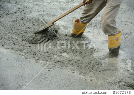 JASIN, MALAYSIA -NOVEMBER 13, 2015: Construction worker leveling wet concrete has been poured. They also use a vibrator machine in this work. 81672178