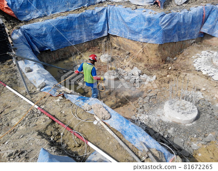 JOHOR, MALAYSIA -MARCH 29, 2016: Construction workers spraying the anti termite chemical treatment to the soil at the construction site.  81672265