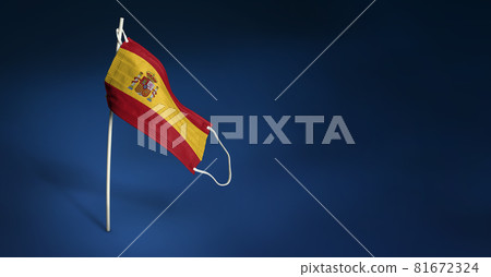 Spain mask on dark blue background. Waving flag of Spain painted on medical mask on pole. Concept of The banner of the fight against the epidemic coronavirus COVID-19 81672324