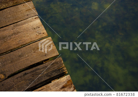 Top view brown wooden planks of bridge over the water of rural lake Top view brown wooden planks of bridge over the water of rural lake 81672338