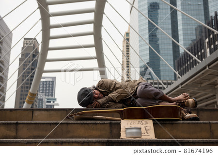 tired beggar or Homeless man sleep on city stair tired beggar or Homeless man sleep on city stair 81674196