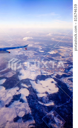 Moscow cityscape covered in snow overlooking from an airplane Moscow cityscape covered in snow overlooking from an airplane 81674639