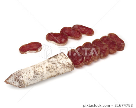 Traditional Spanish Fuet thin dried sausage with slices, Close-up, isolated on a white background Traditional Spanish Fuet thin dried sausage with slices, Close-up, isolated on a white background 81674798