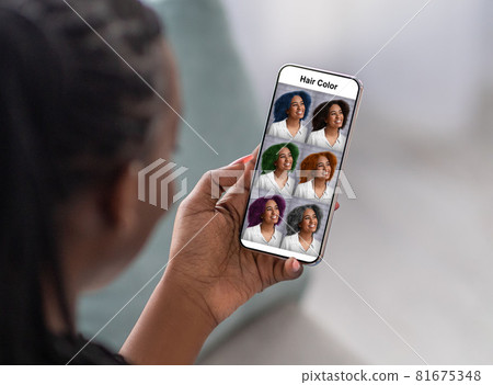 Black woman checking hair color simulation mobile application on smartphone Black woman checking hair color simulation mobile application on smartphone 81675348