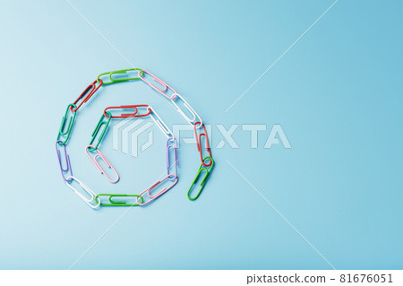 A chain of multi-colored paper clips on a blue background A chain of multi-colored paper clips on a blue background 81676051