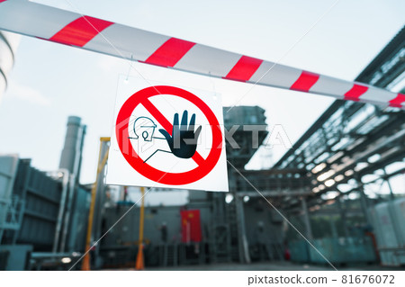 A sign prohibiting the passage of outsiders on a poster with a red and white ribbon. 81676072