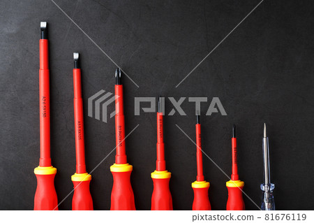 The tool is red screwdrivers in a row on a black background with a free space. 81676119
