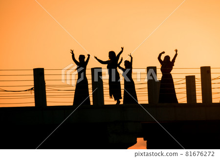 Georgian dancing on the pier in sunset 81676272