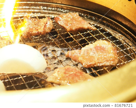 Beef ribs and onions on a grill at a yakiniku restaurant Beef ribs and onions on a grill at a yakiniku restaurant 81676721