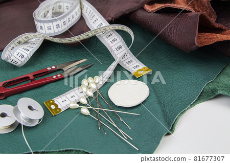 A piece of leather with scissors, needles, chalk, A piece of leather with scissors, needles, chalk, 81677307