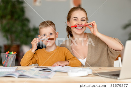 funny mother and child son playing and doing homework writing and reading funny mother and child son playing and doing homework writing and reading 81679277