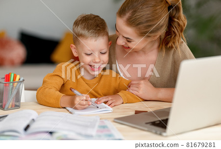 Happy mother supporting son during online studies 81679281