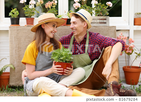 Optimistic couple hugging and resting in orangery 81679284