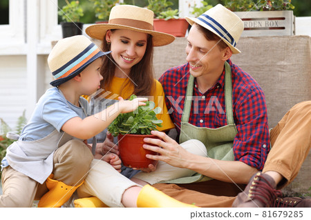 Optimistic family hugging outside orangery 81679285