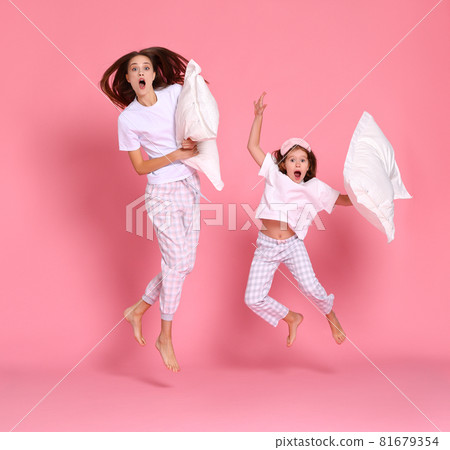 Excited mother and daughter jumping in morning Excited mother and daughter jumping in morning 81679354