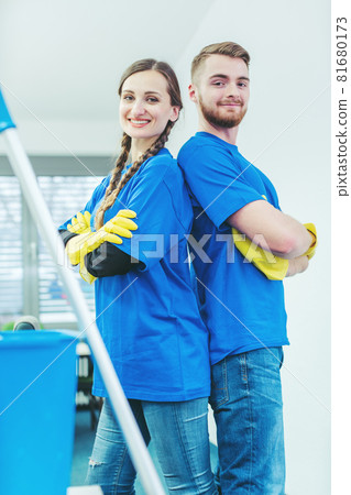 Cleaners being proud of their service standing arms folded 81680173
