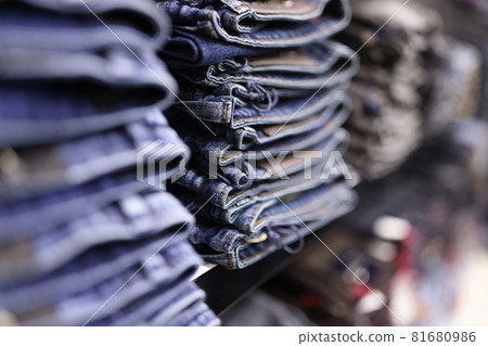 Stack of blue jeans in different shades at store closeup 81680986