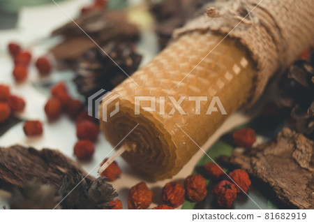 Wax candle handmade close-up. Festive decor of berries and bark. Wax candle handmade close-up. Festive decor of berries and bark. 81682919
