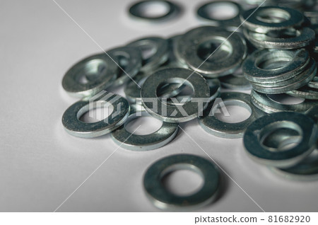 A scattering of metal washers for bolts and screws. A scattering of metal washers for bolts and screws. 81682920