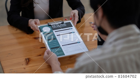 job interview in office, focus on resume writing tips, employer reviewing good cv of prepared skilled applicant, recruiter considering application, hr manager making hiring decision. job interview in office, focus on resume writing tips, employer reviewing good cv of prepared skilled applicant, recruiter considering application, hr manager making hiring decision. 81684702