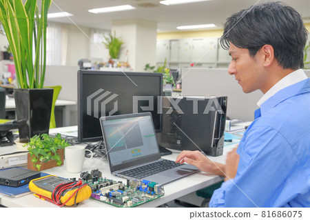 Electrical engineer reaching for the touchpad 1 Electrical engineer reaching for the touchpad 1 81686075