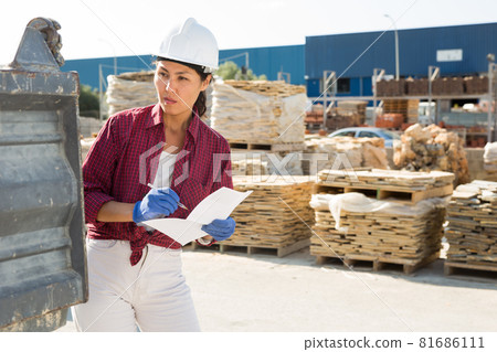 Asian woman worker posing at hardware store 81686111