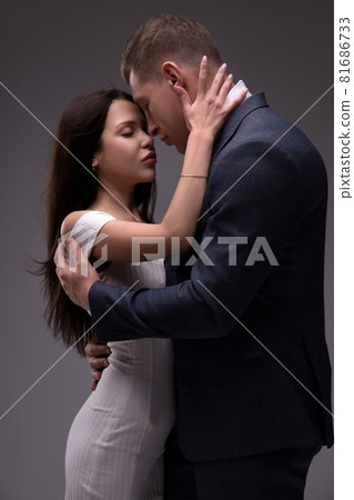 Loving young couple embracing tenderly in studio Loving young couple embracing tenderly in studio 81686733