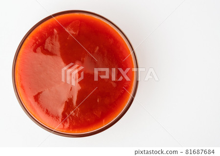 Tomato ketchup in glass bowl on white background. 81687684