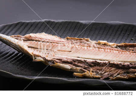 Grilled pacific saury fish on a black plate 81688772