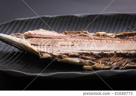 Grilled pacific saury fish on a black plate 81688773