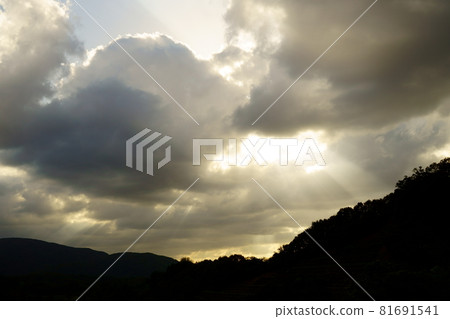 Angel's Ladder in the Evening Hanging over the Silhouette of a Mountain - Full View Angel's Ladder in the Evening Hanging over the Silhouette of a Mountain - Full View 81691541